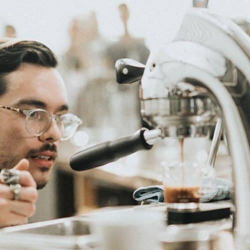 A barista carefully brewing a cup of coffee
